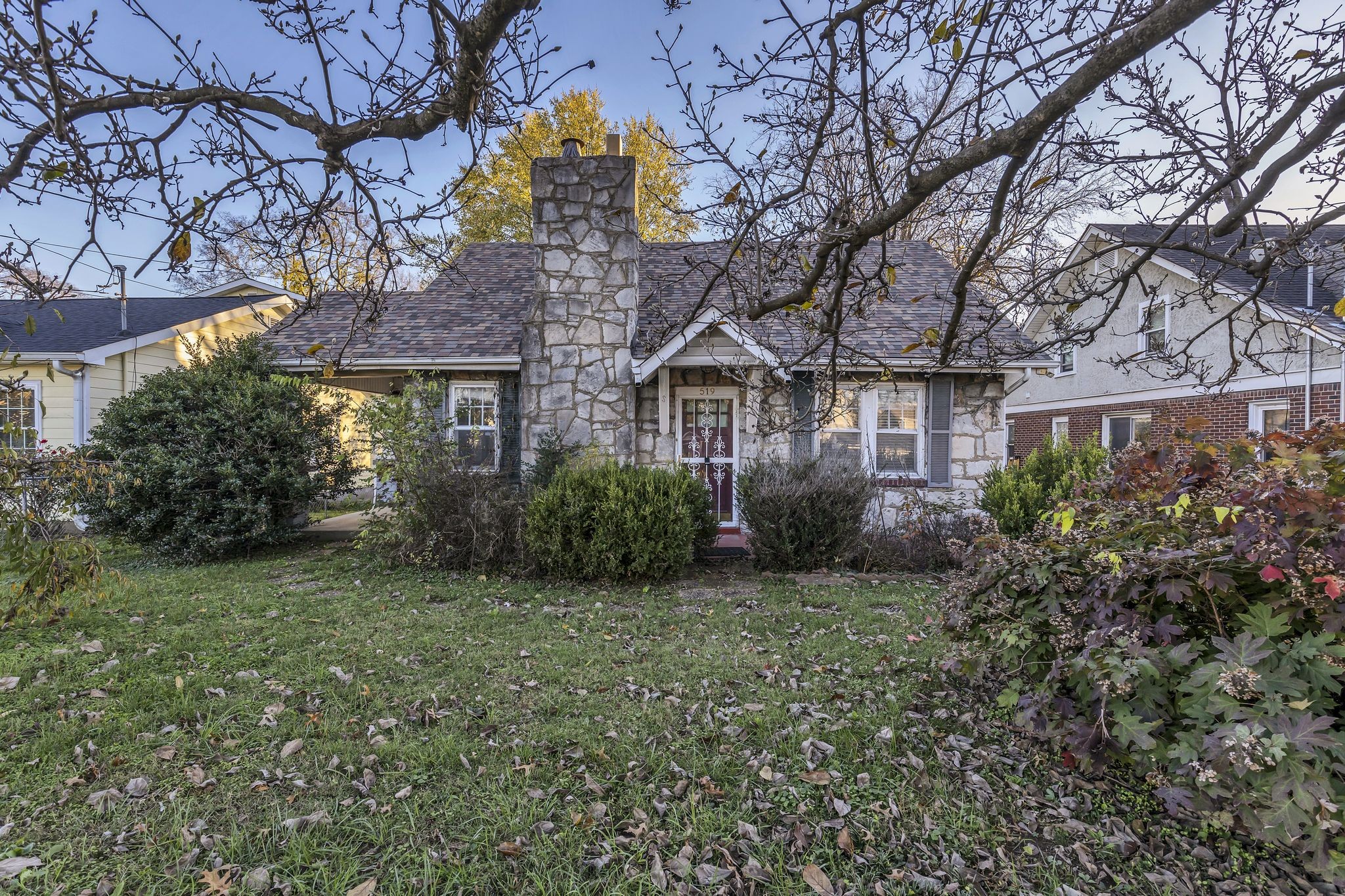 a view of a house with a small yard and tree s