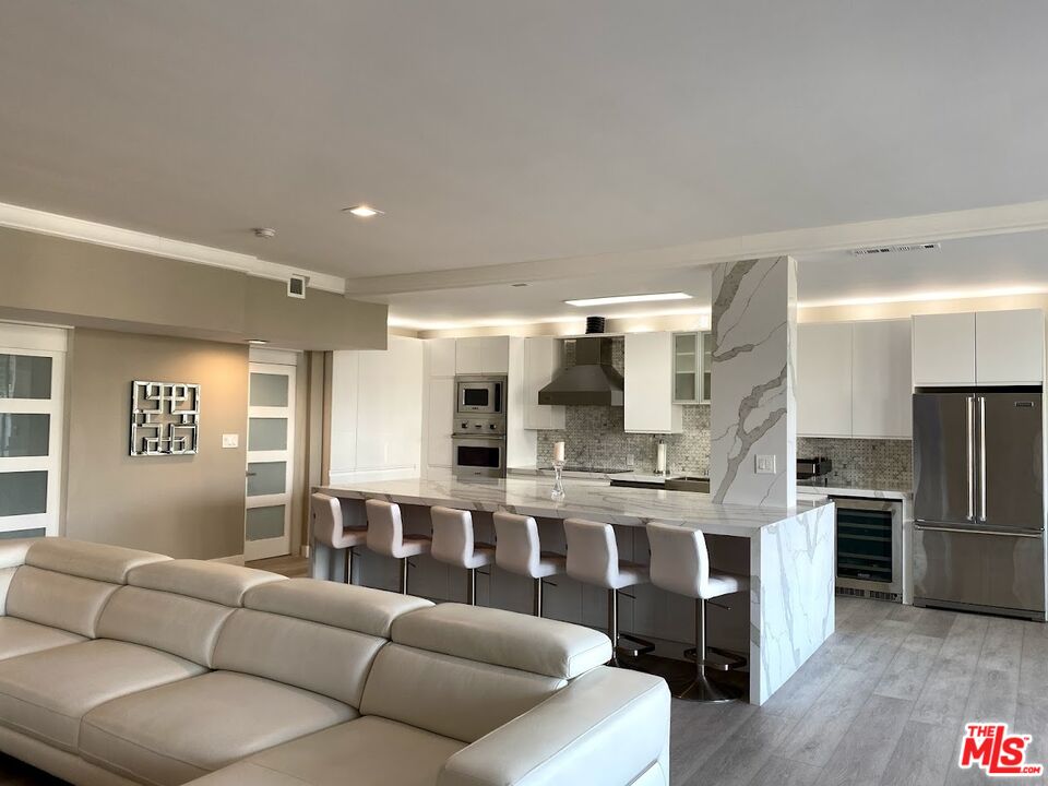 a living room with stainless steel appliances kitchen island granite countertop a kitchen view and living room view