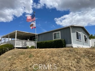 a house that has a tree in front of it