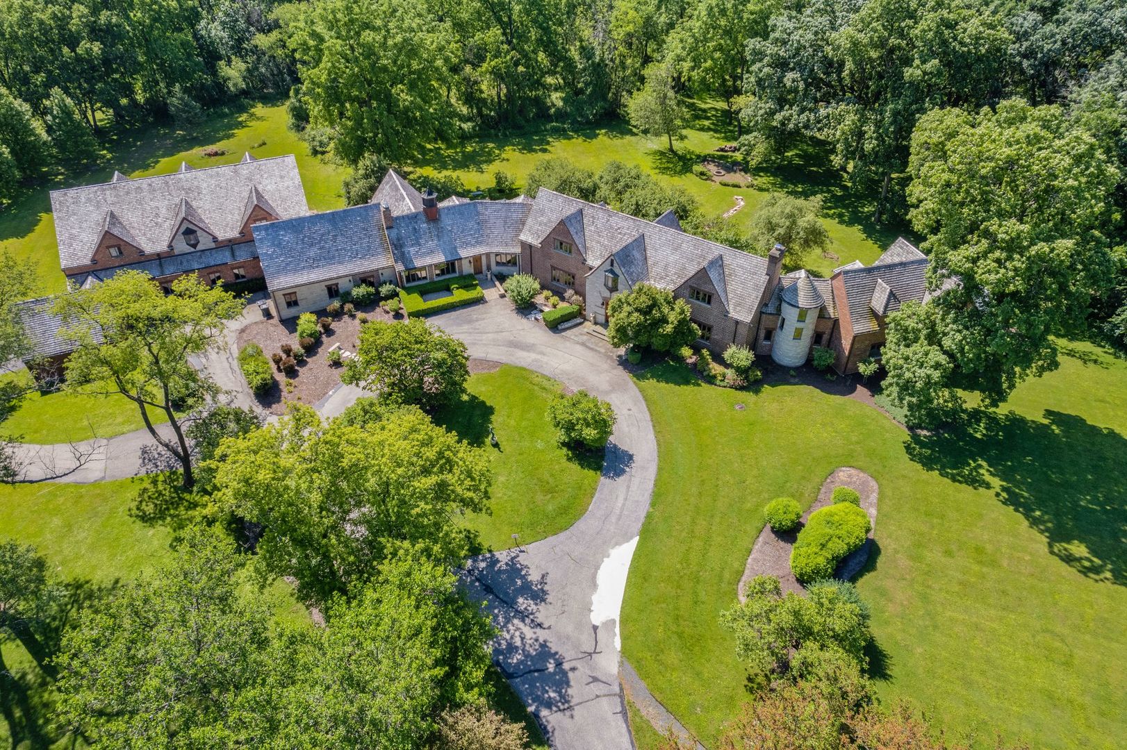 an aerial view of a house with swimming pool and garden