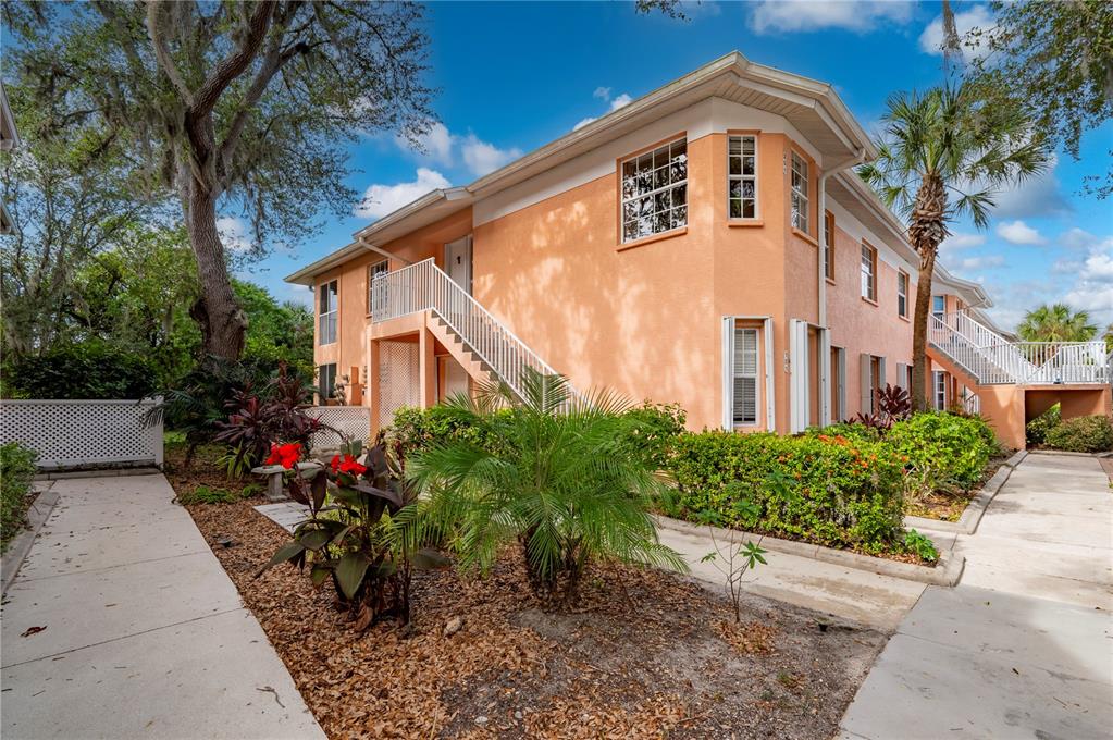 a front view of a house with plants