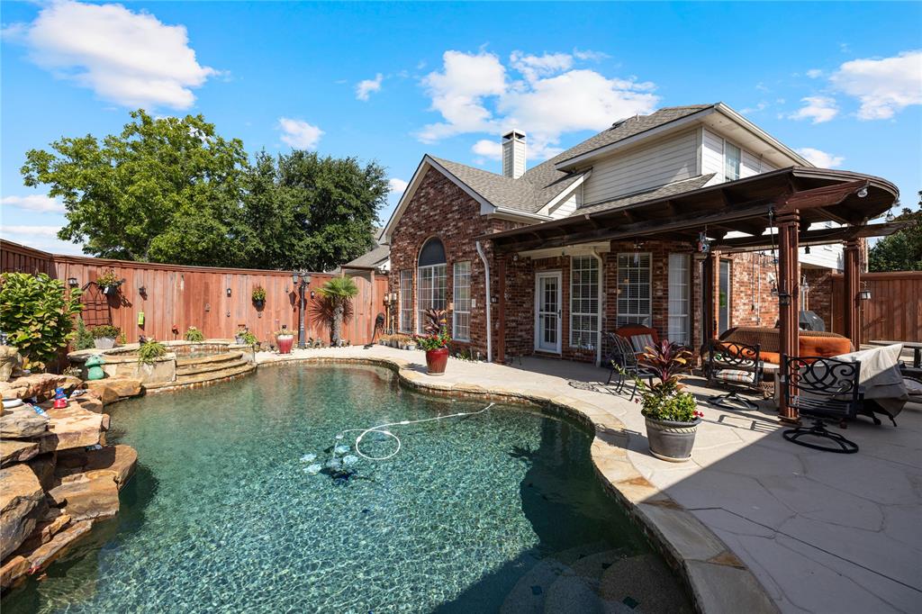 a view of a house with swimming pool and sitting area