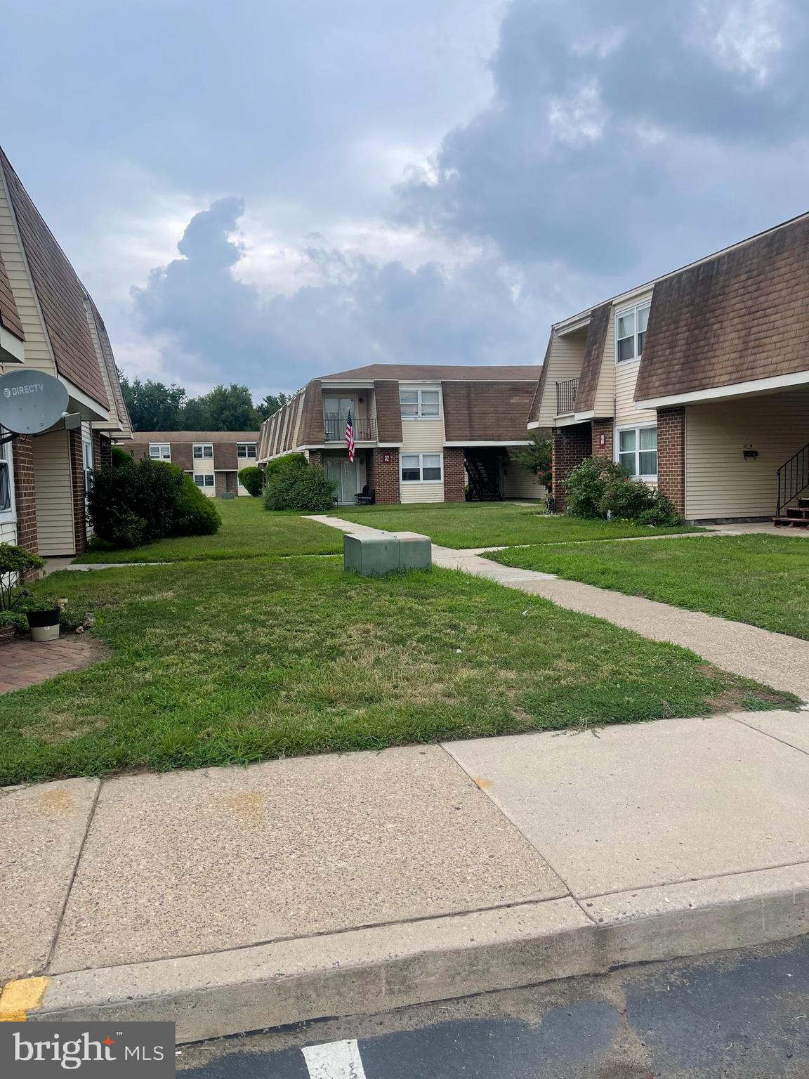 a front view of a house with a yard and a garage