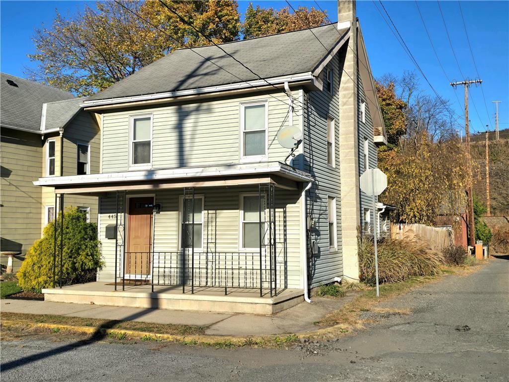 a front view of a house with a road