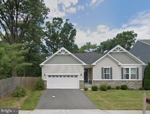 a view of house with yard and green space