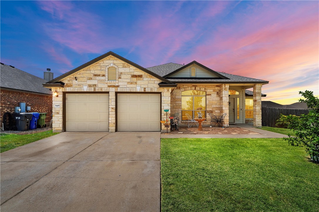 a front view of a house with yard and garage