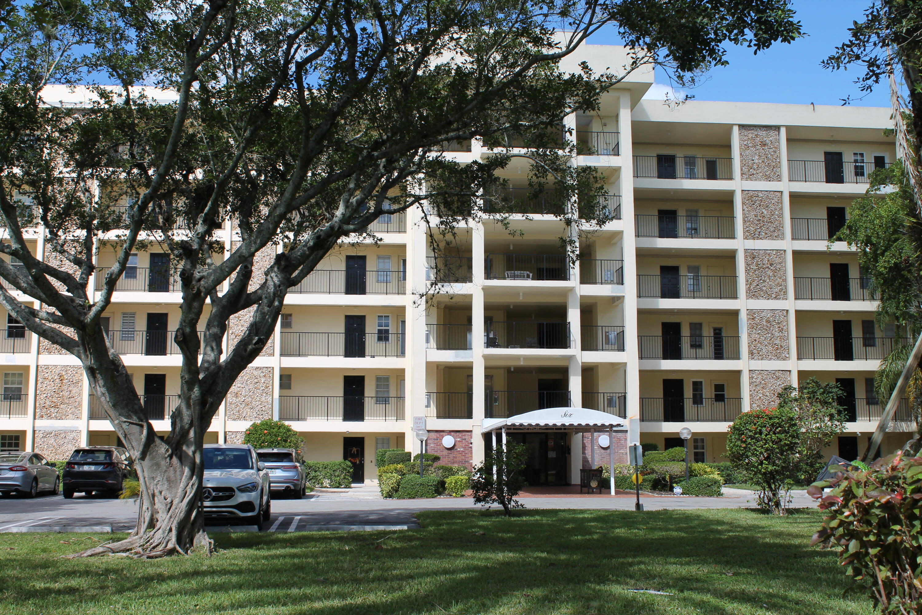 a front view of a building with a garden