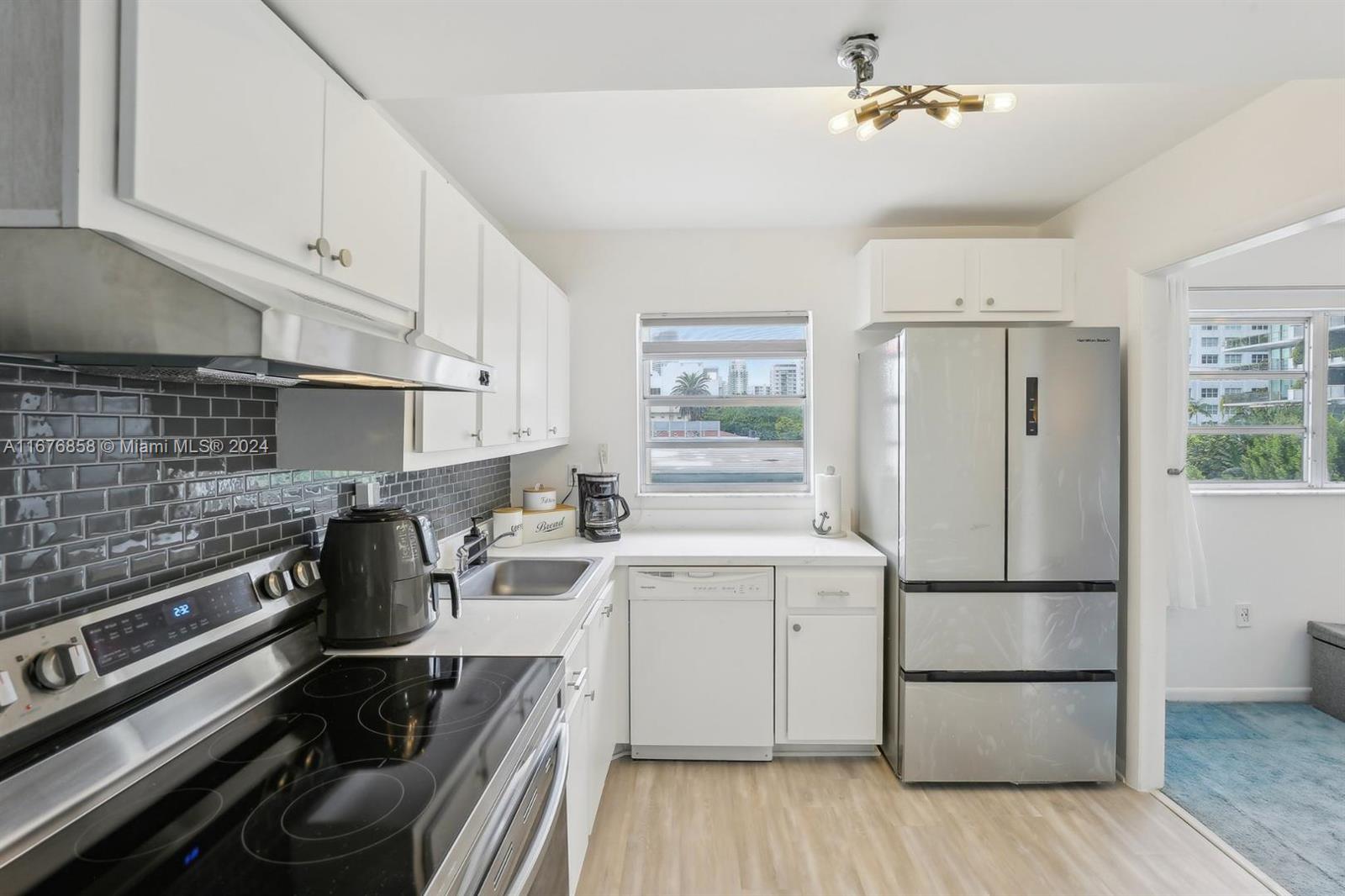 a kitchen with a refrigerator and a stove top oven