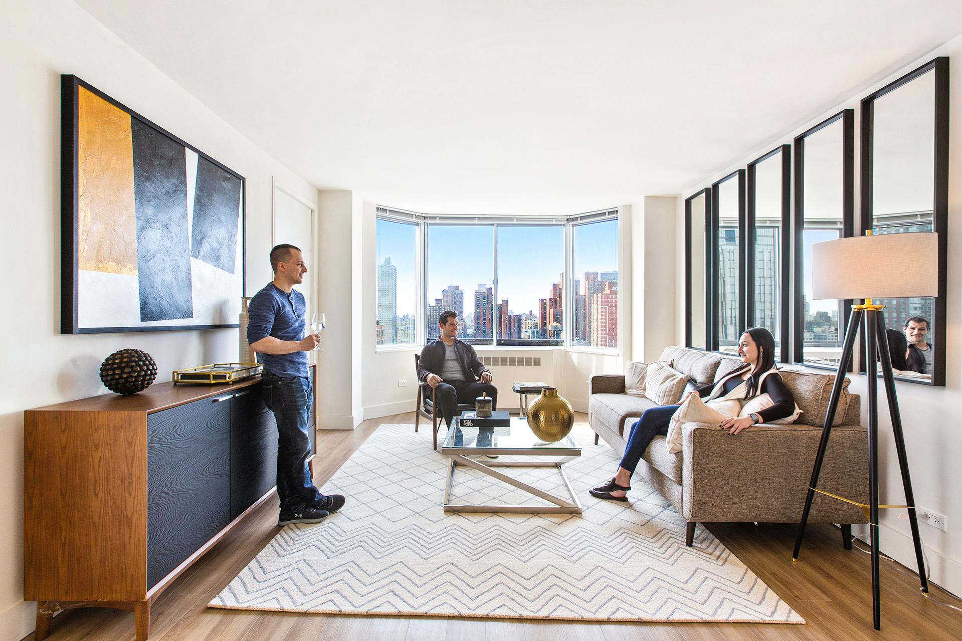 a living room with furniture and large windows