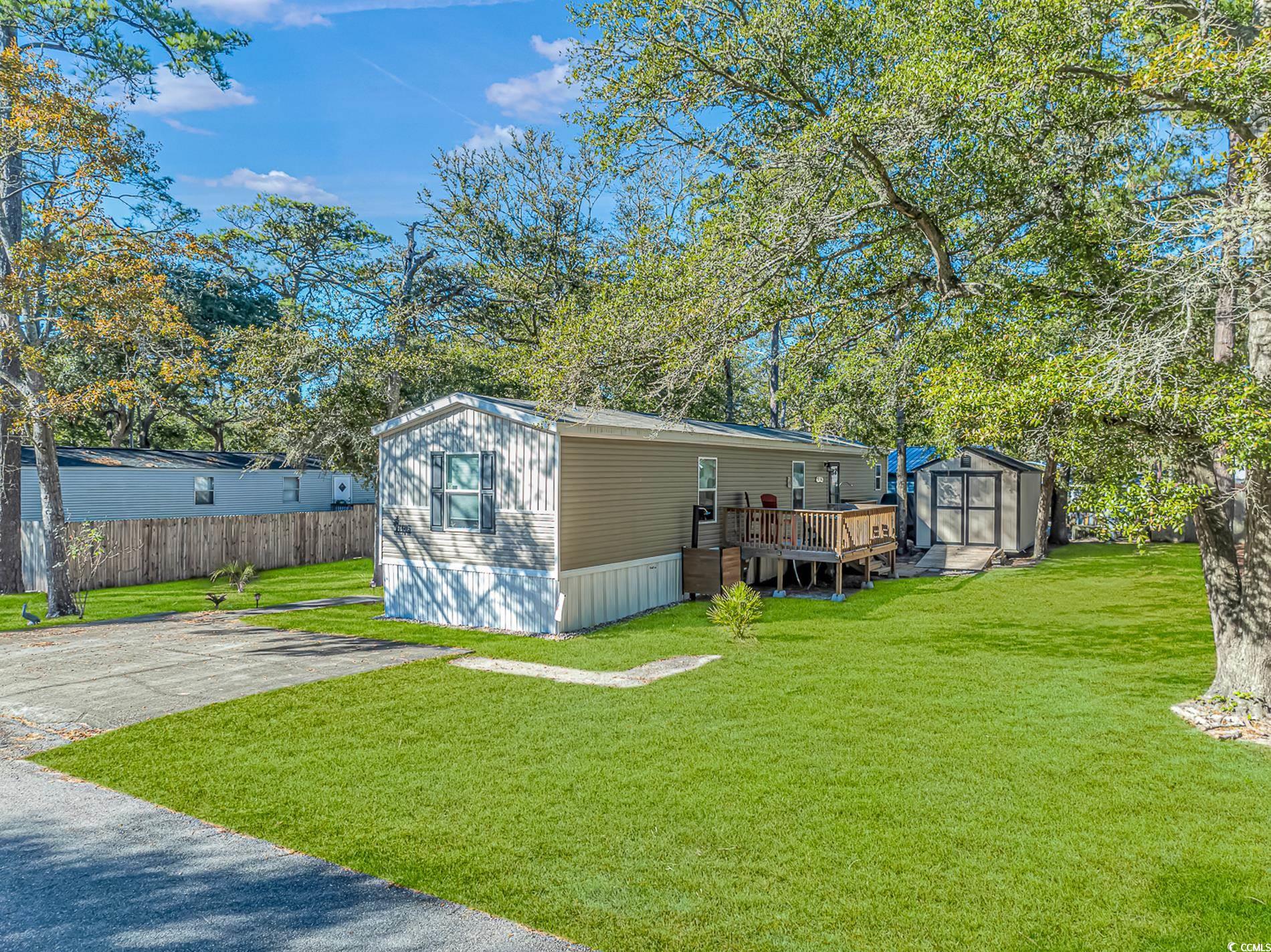 View of outdoor structure with a lawn