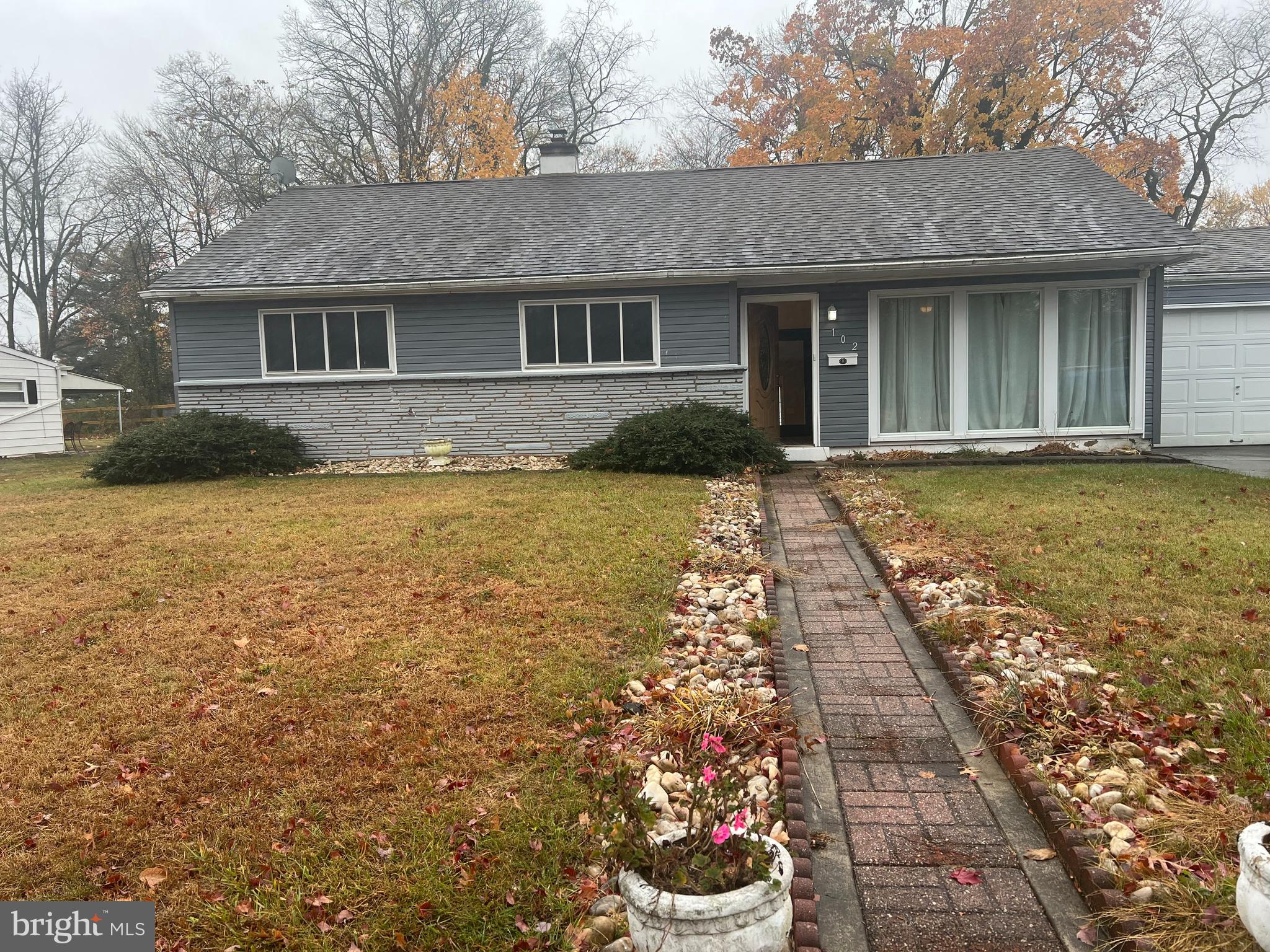 a front view of a house with a garden