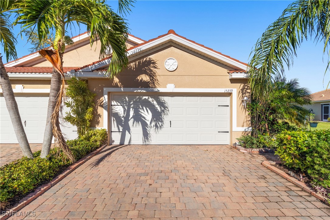 a front view of a house with a yard and a garage