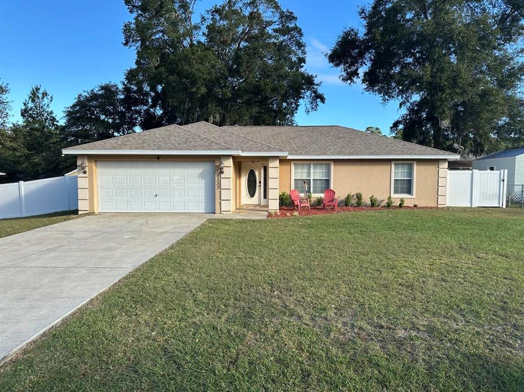 a front view of house with yard and green space