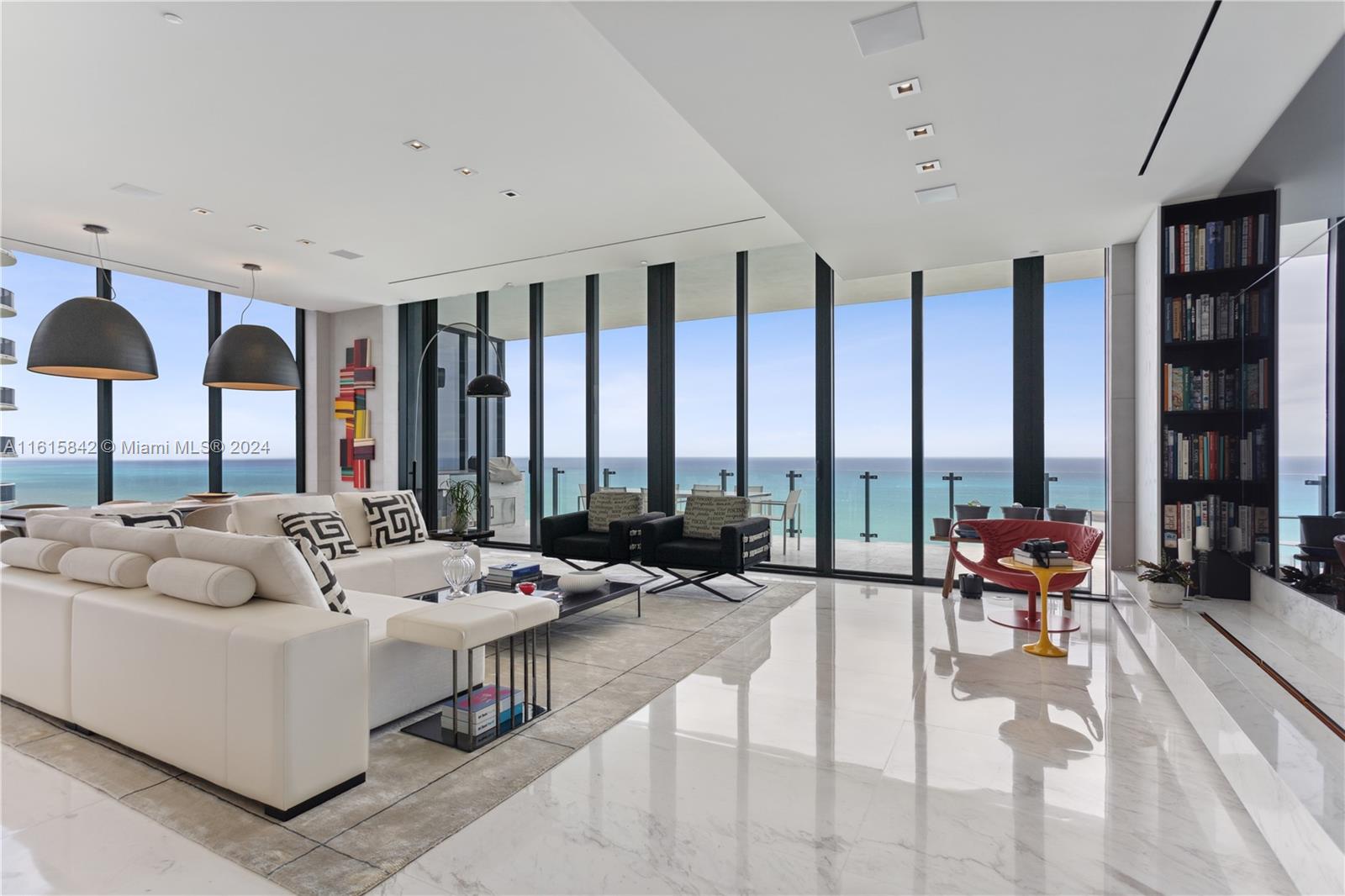 a living room with furniture and large windows