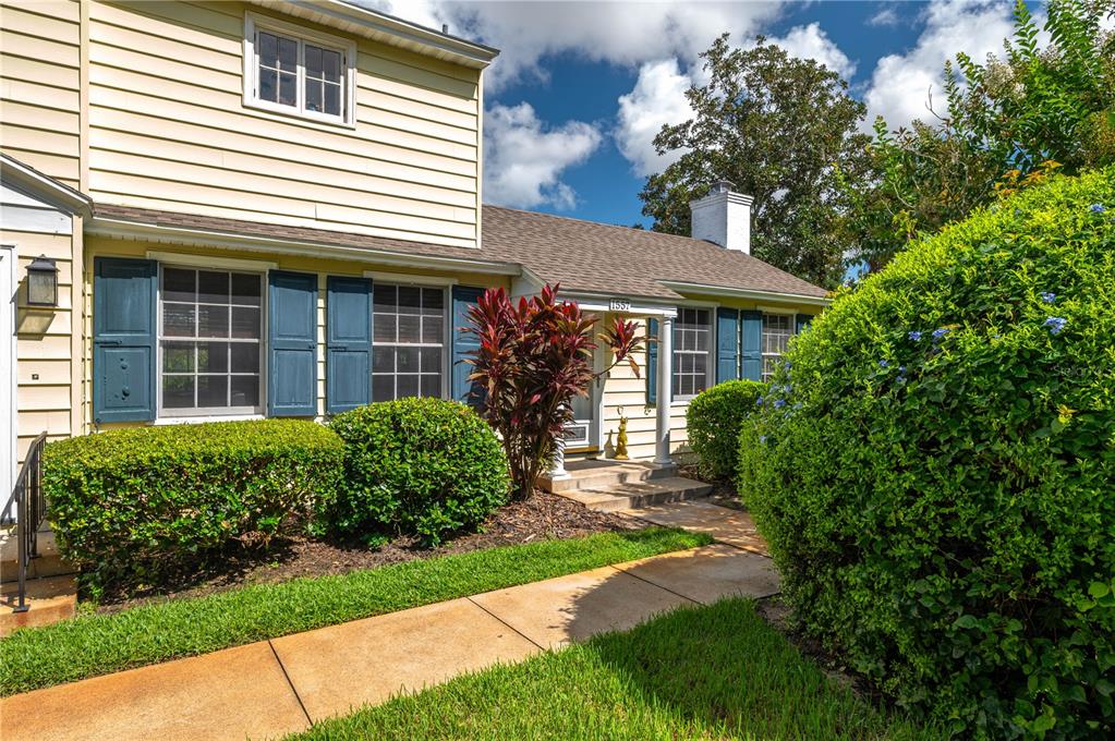 a front view of a house with garden