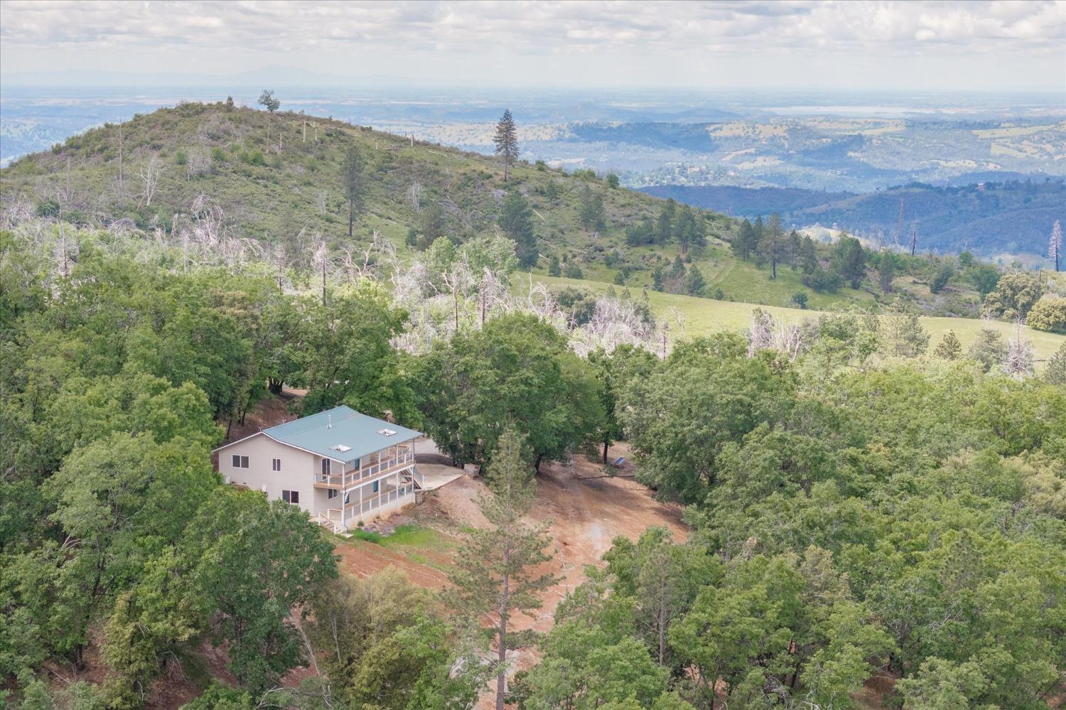 an aerial view of a house with a yard