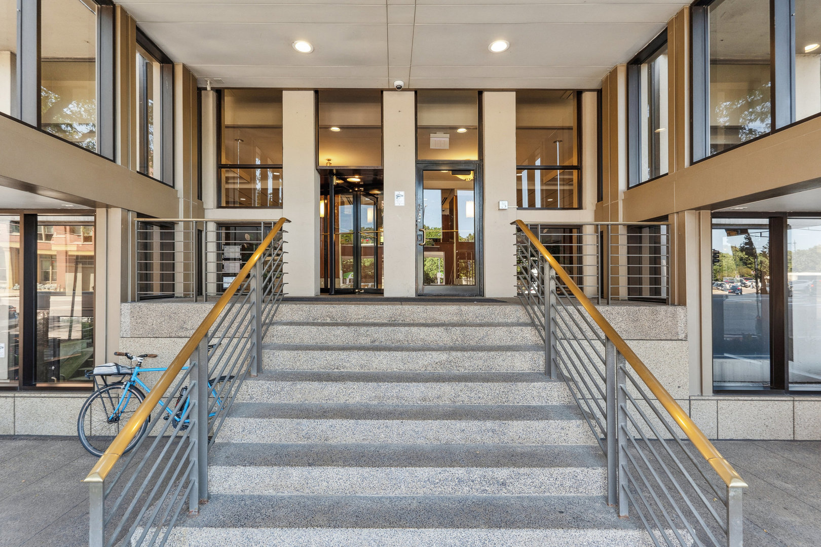 a view of staircase with lots of frames on wall and a table