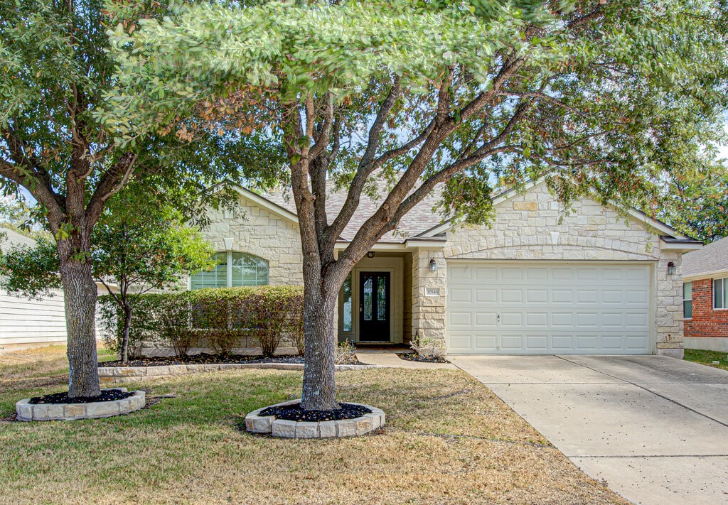 a front view of house with a garden