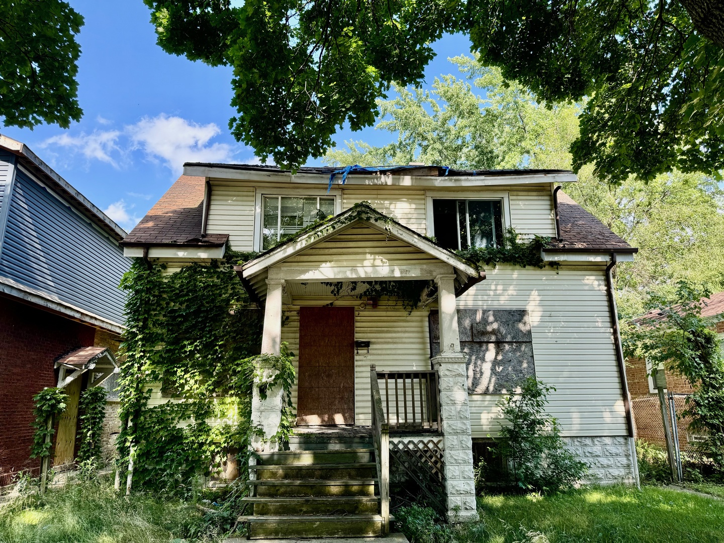 a front view of house with yard and trees in the background