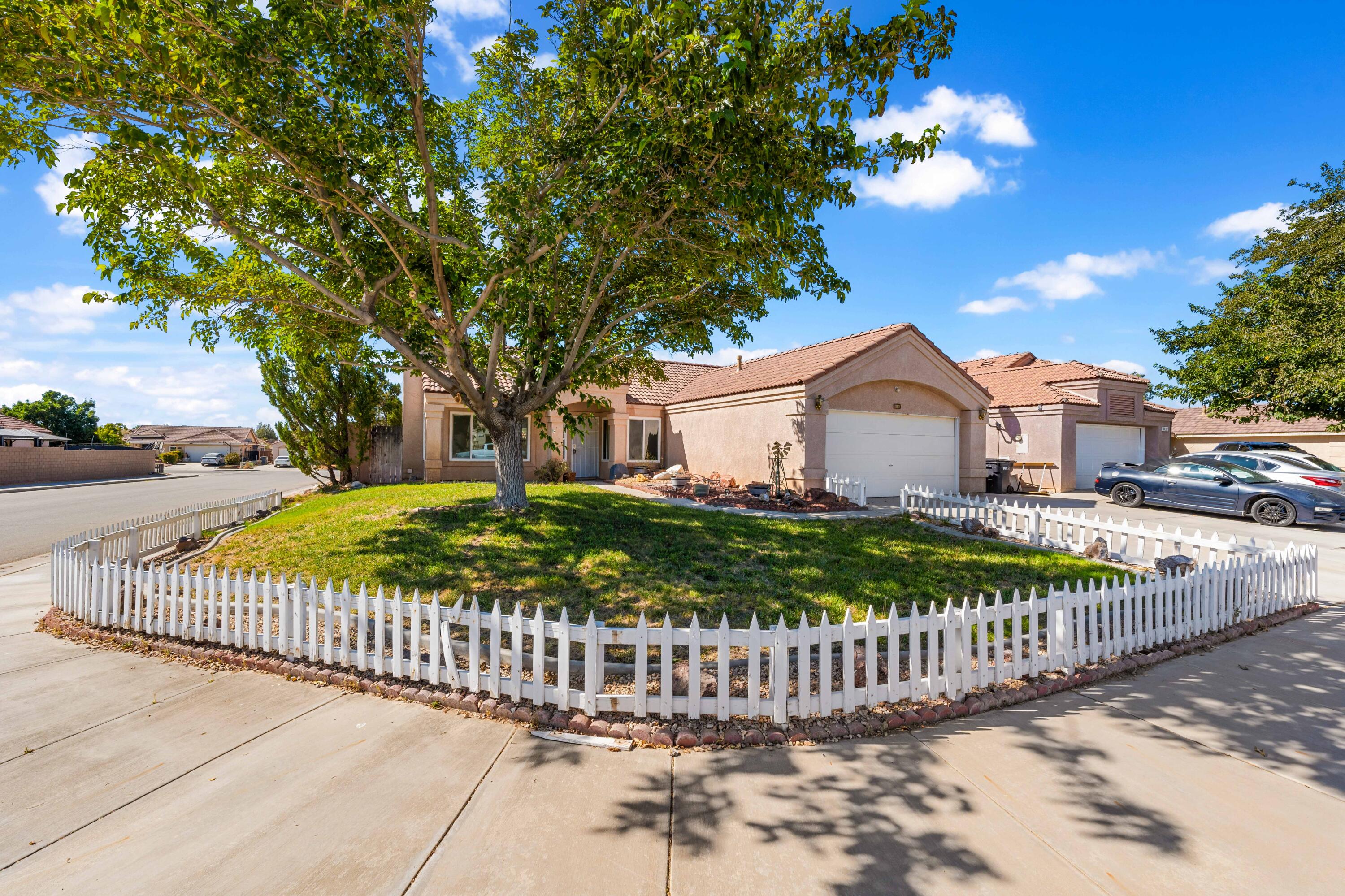 a view of a house with a small yard and wooden fence