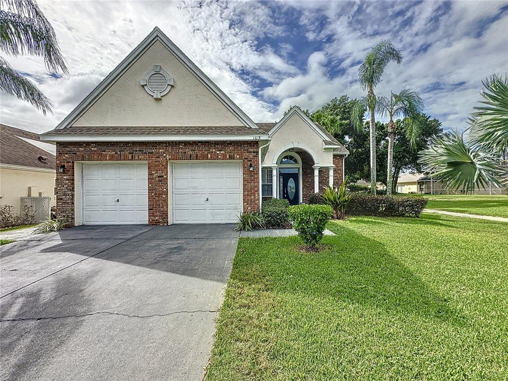 a front view of a house with a yard and garage