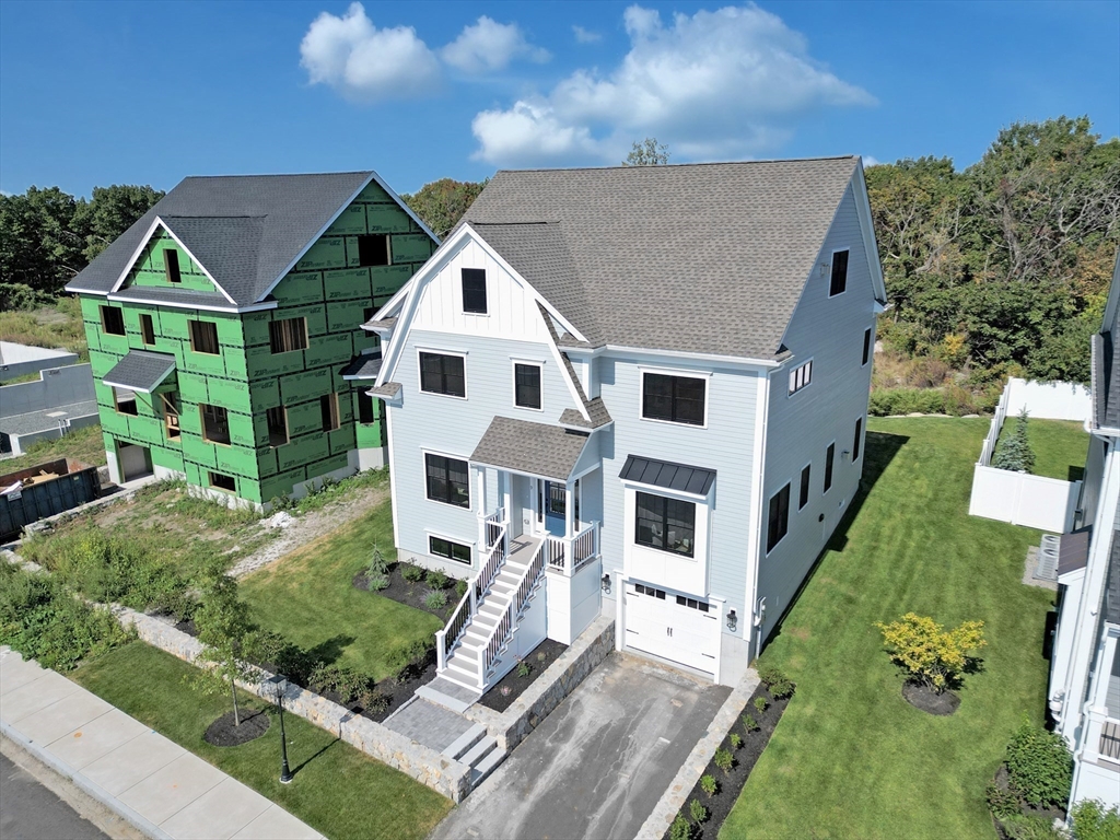 an aerial view of a house with a yard