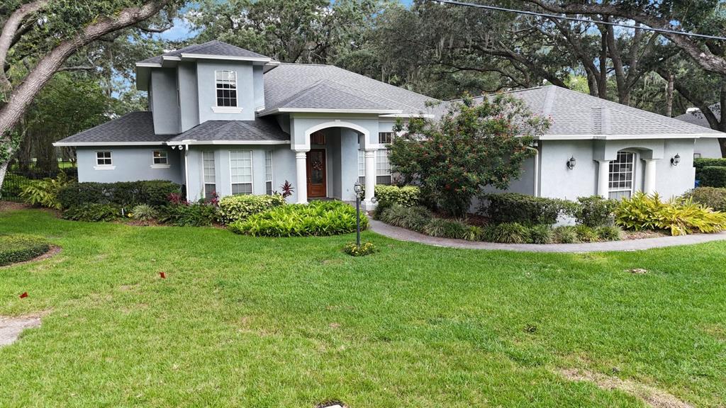 a front view of a house with a garden