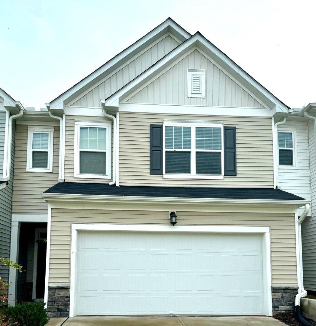 a front view of a house with a garage