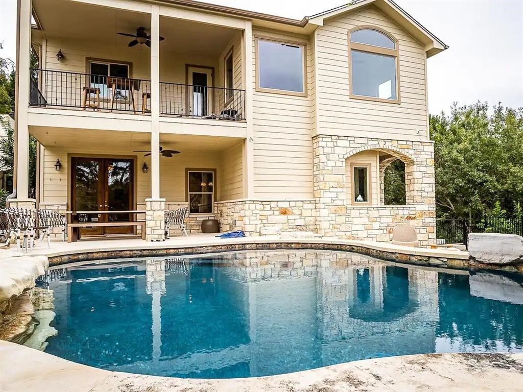 a swimming pool view with a outdoor seating