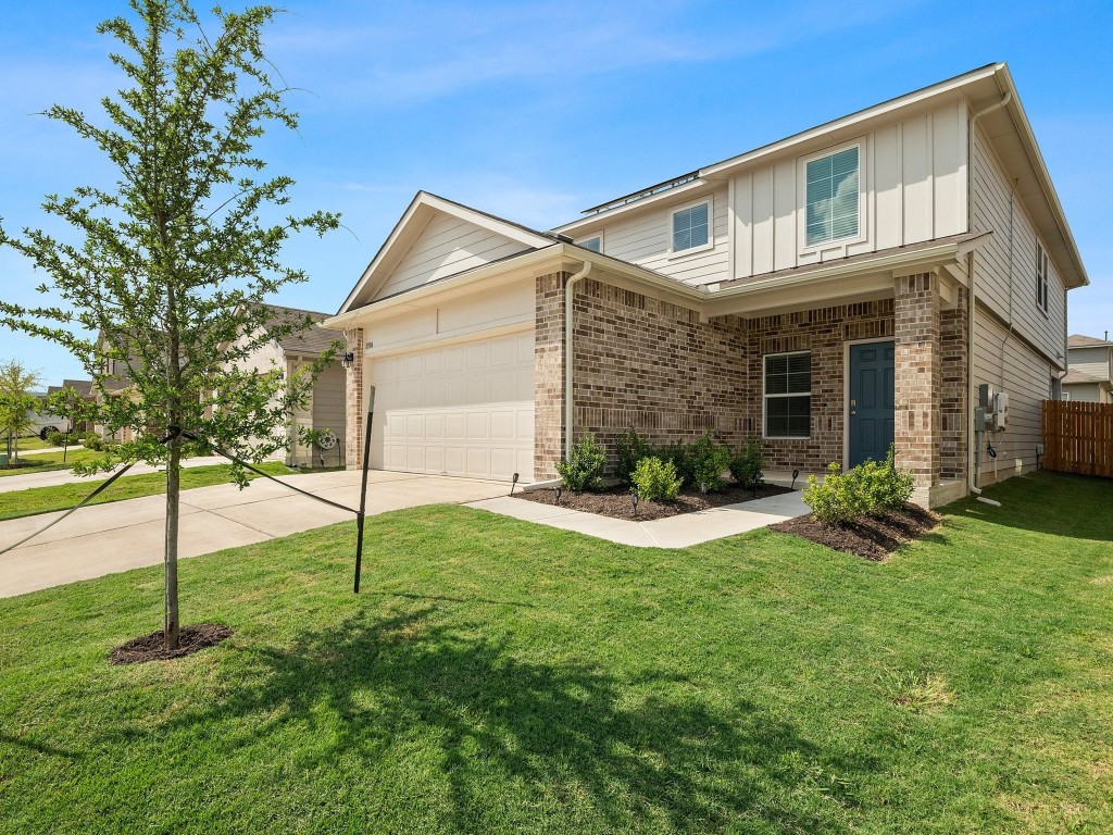 a front view of house with yard and green space