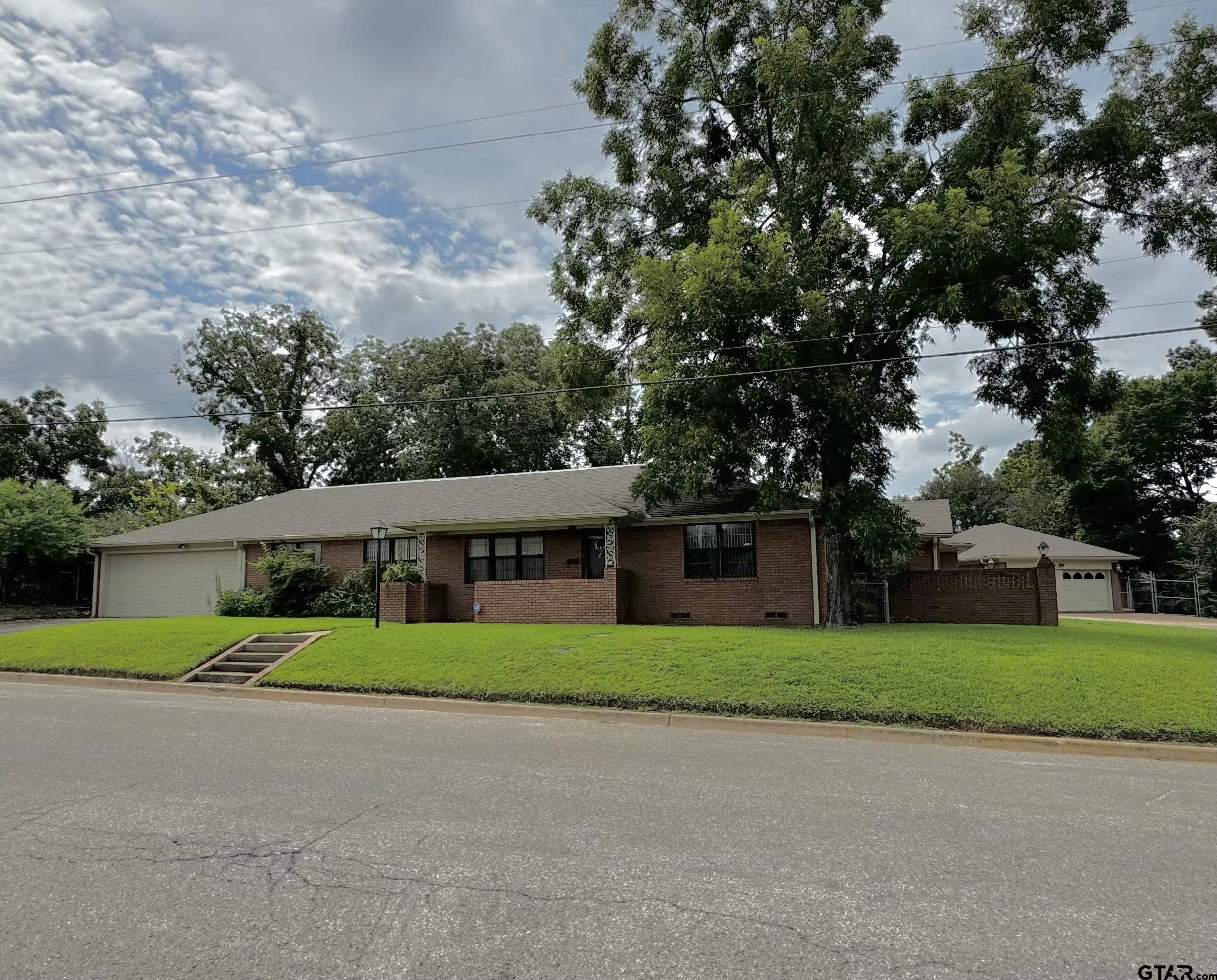 a front view of house with yard and green space