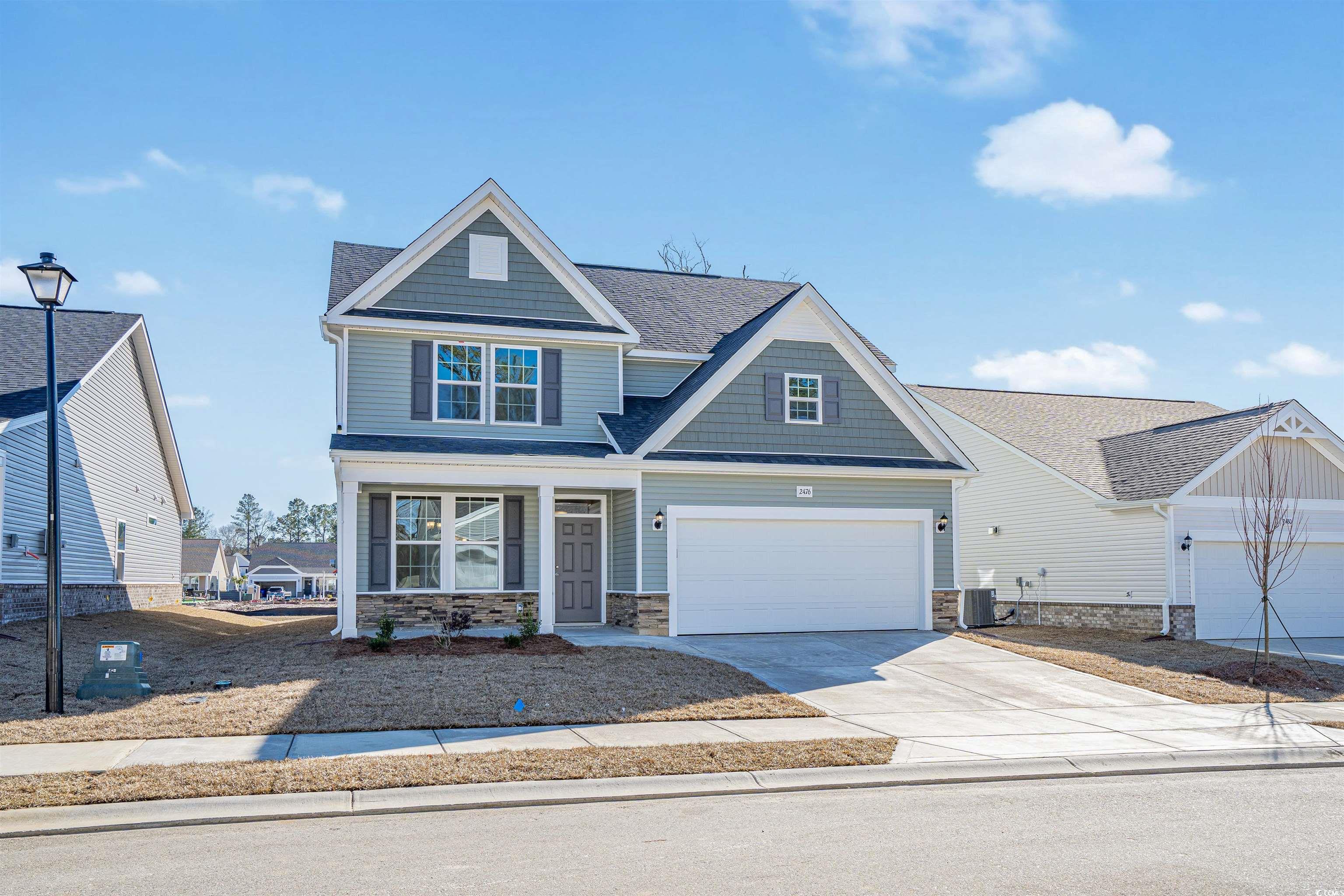 Craftsman-style house with a garage, central AC, a