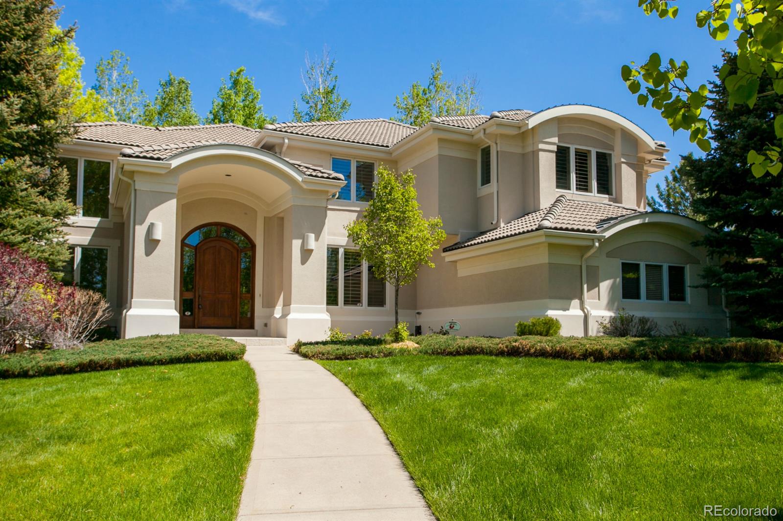 a front view of a house with a garden