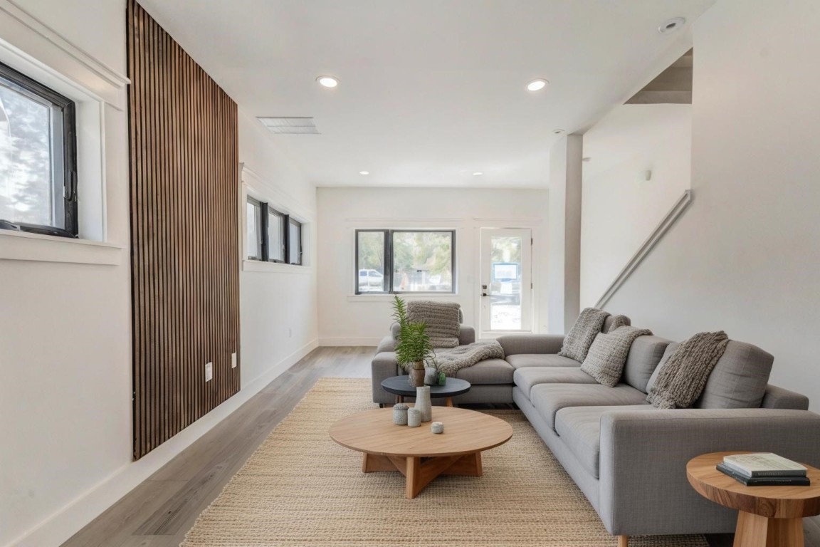 a living room with furniture and a wooden floor