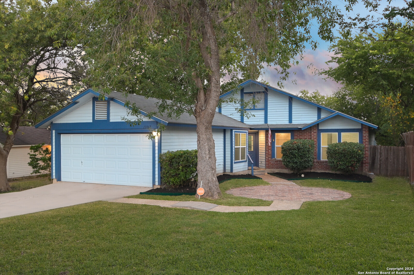 a front view of a house with a yard and garage