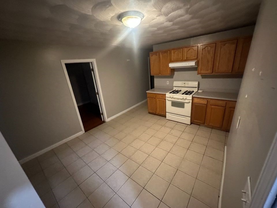 a kitchen with stainless steel appliances a stove a sink and a refrigerator