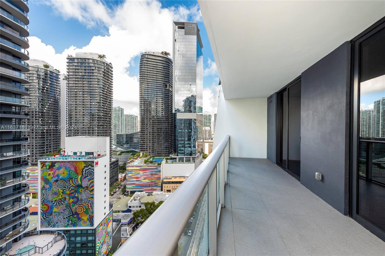 a balcony with city view and outdoor seating