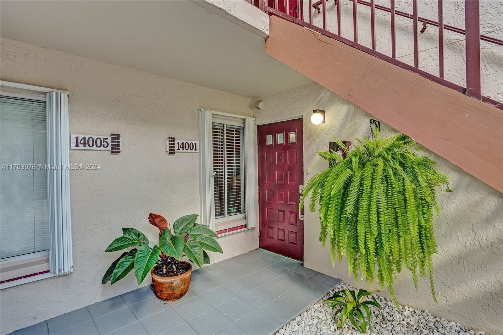 a potted plant sitting in front of a house