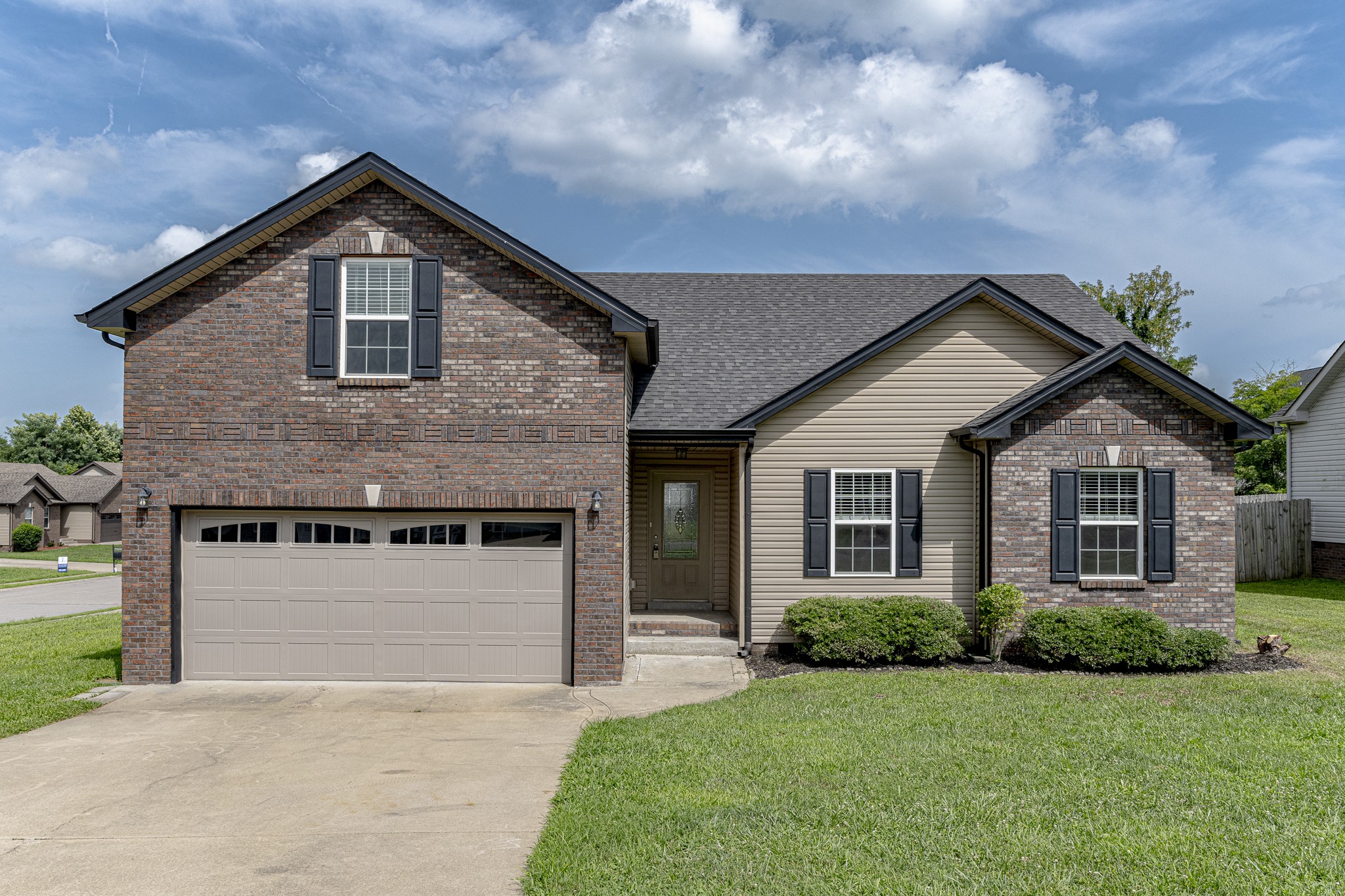 a front view of a house with a yard and garage