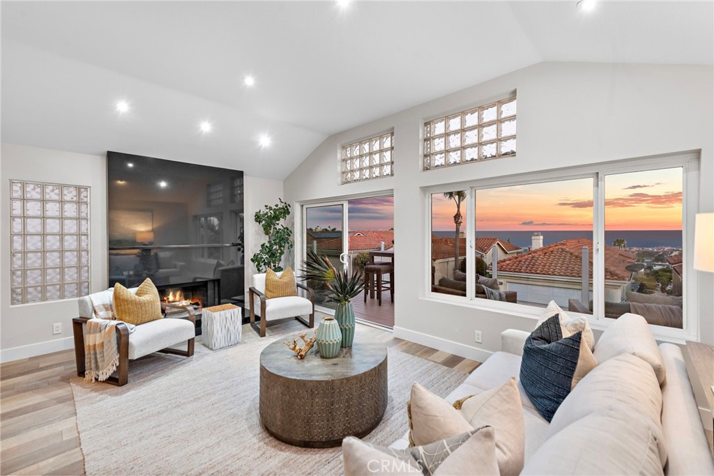 a living room with furniture large window and a fireplace