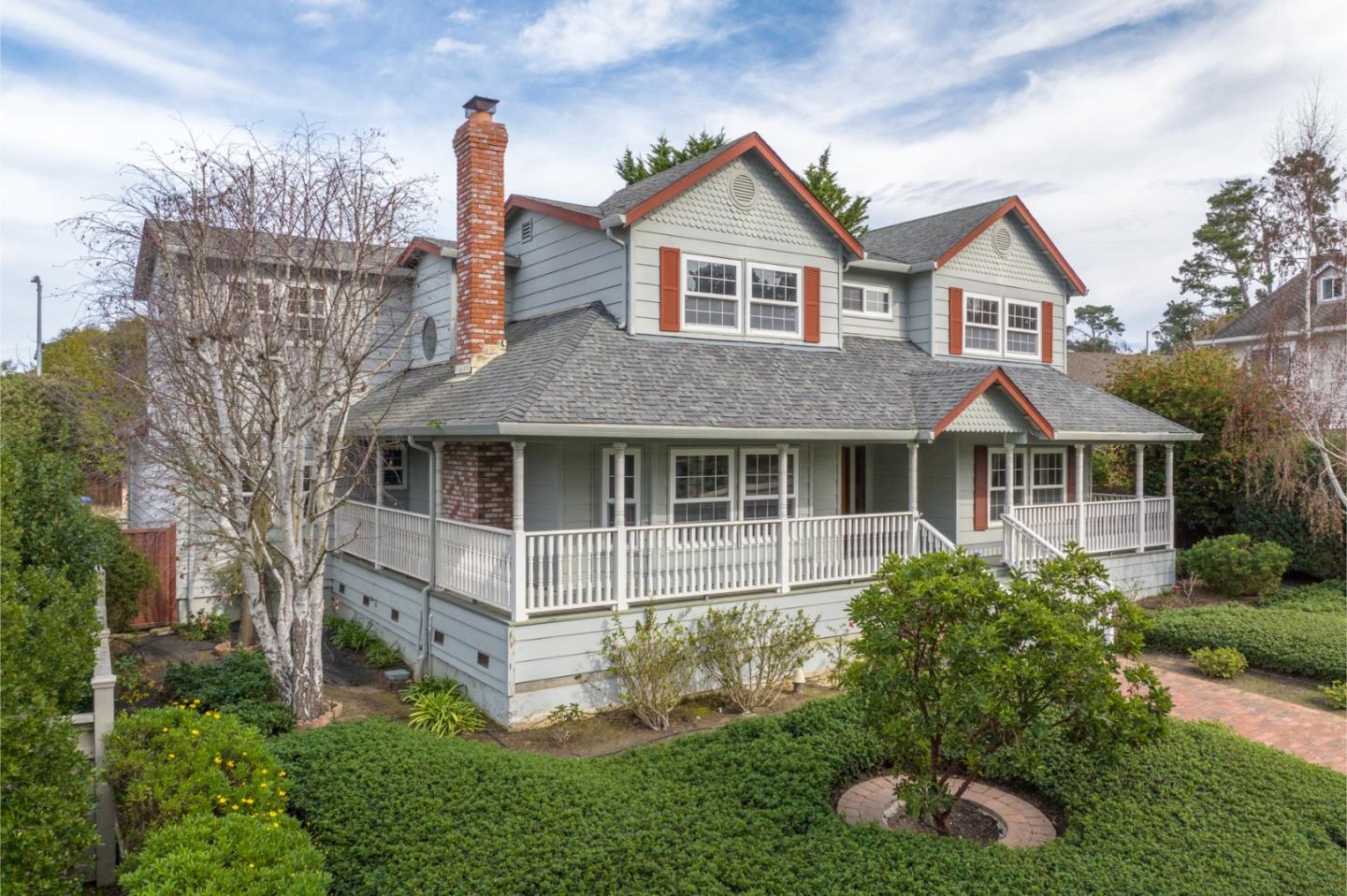 a aerial view of a house with yard and porch