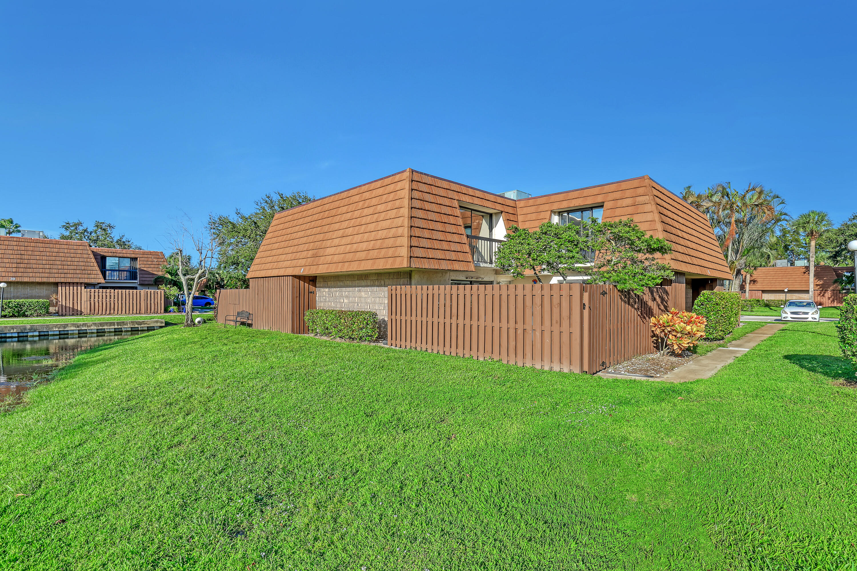 a view of a house with a yard and deck