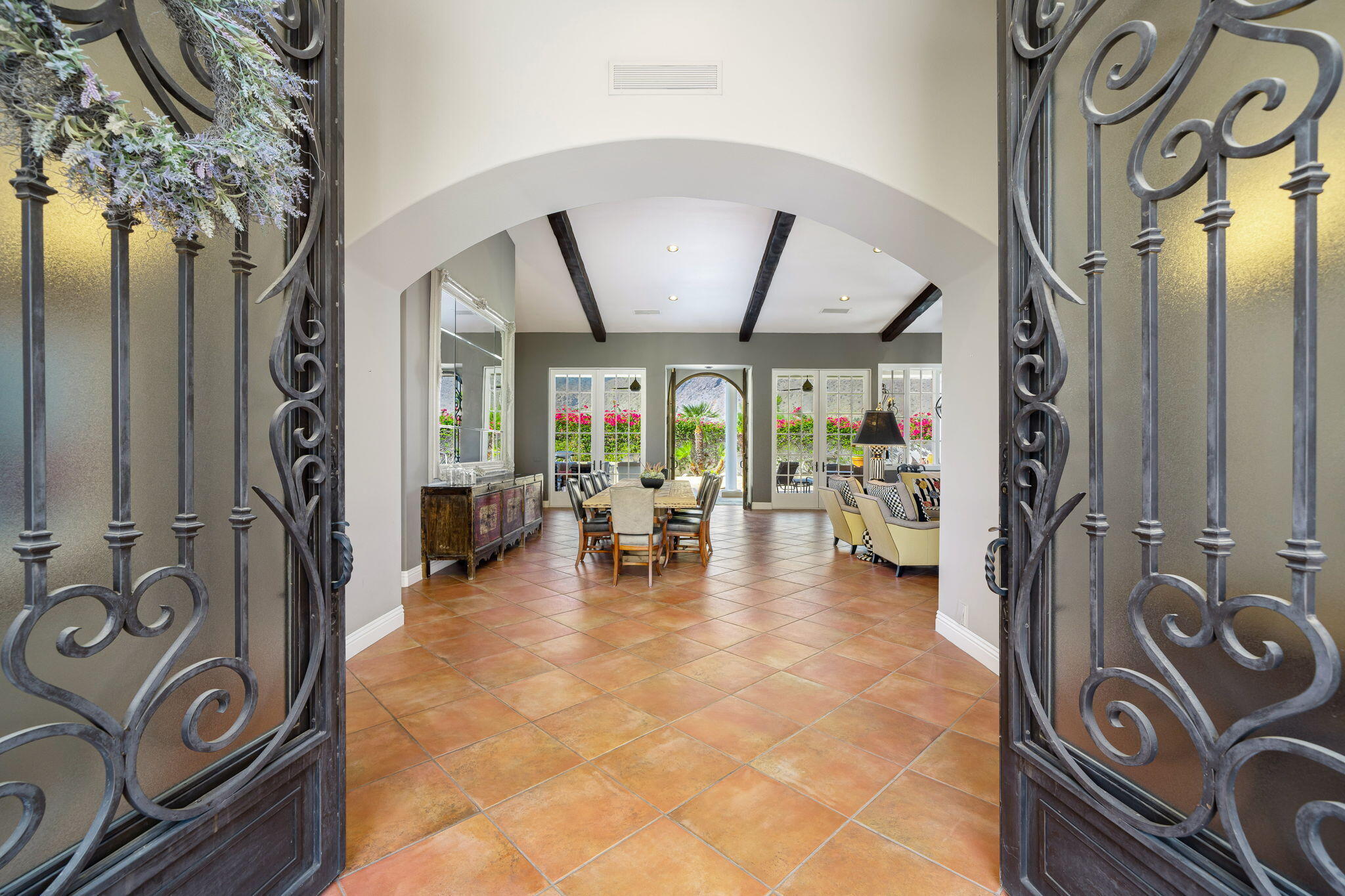 an entryway with a dining table and a chandelier