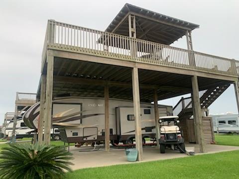 a roof deck with table and chairs a barbeque with wooden fence