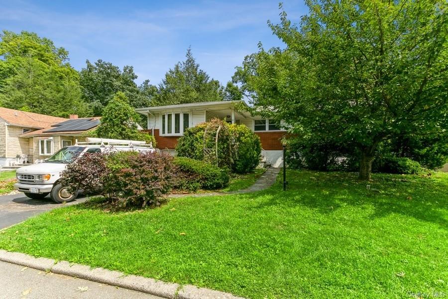 a front view of a house with a garden