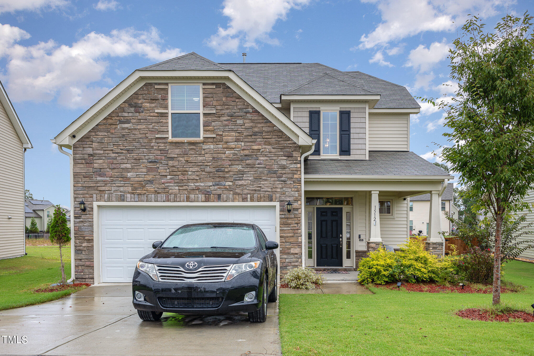 a front view of a house with a garden