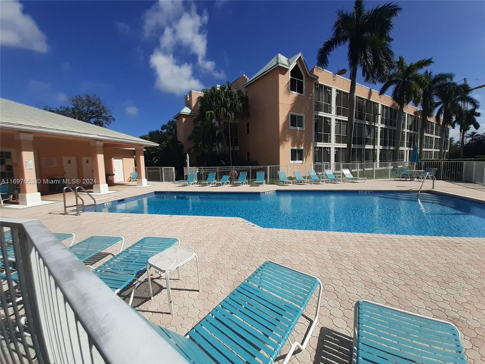 a view of a house with swimming pool and sitting area