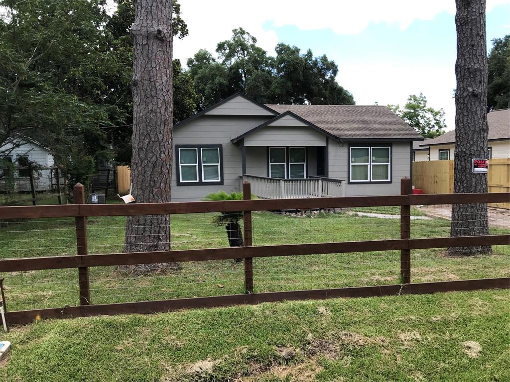 Front of home showing fenced yard and inviting porch area.