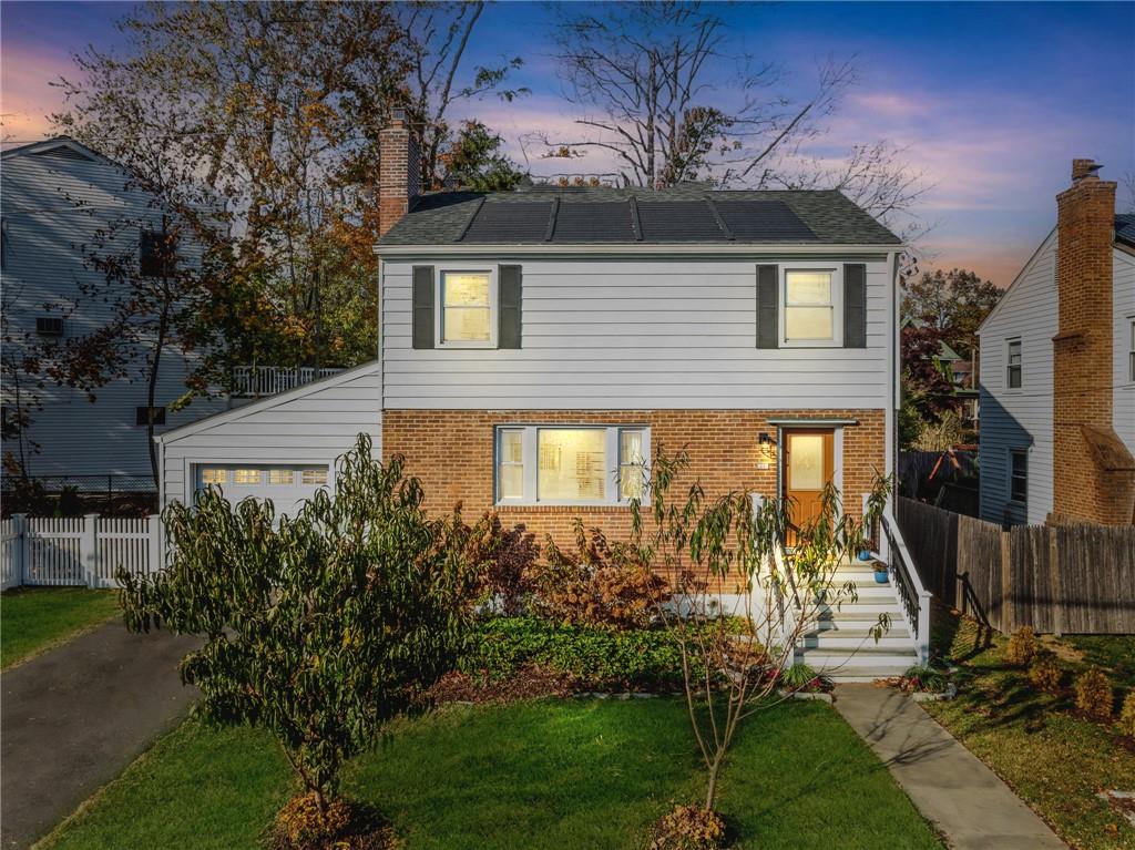 a front view of a house with a yard