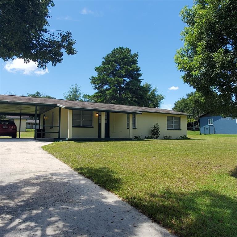 a front view of a house with a yard and trees